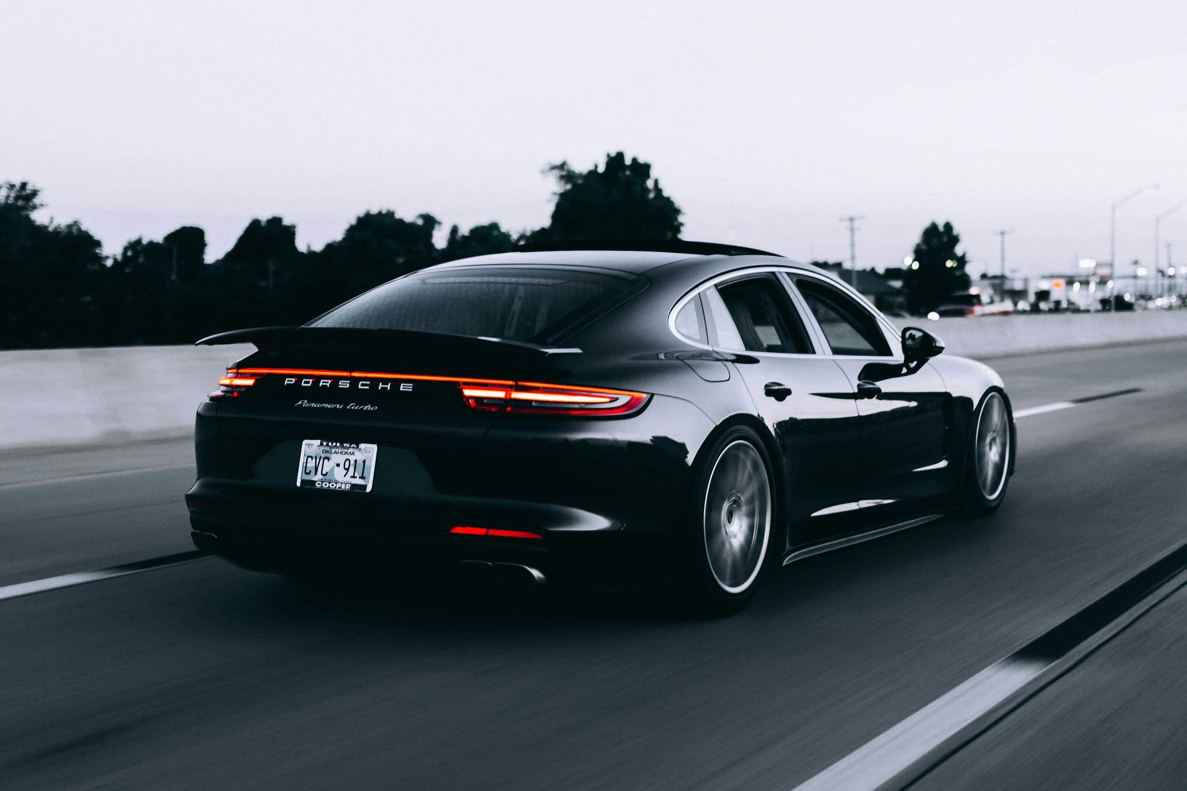 Sleek used car on a wet road at dusk